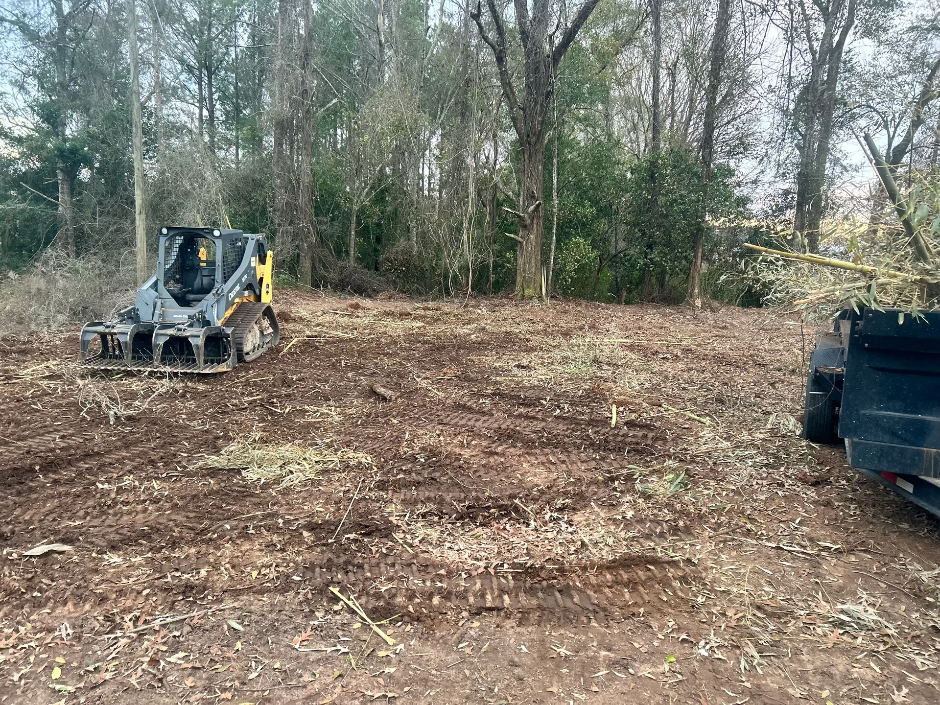 Equipment working on a wooded property